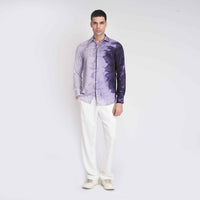 Front view of the purple ombre tie-dye shirt, full length with white trousers
