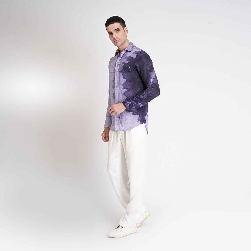Side view of the purple ombre tie-dye shirt with white trousers