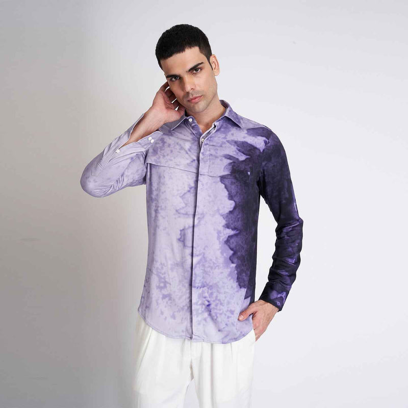 Front view of the purple ombre tie-dye shirt styled with white trousers