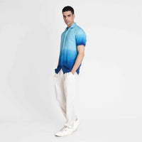 Side view of the blue ombre camp shirt with white trousers