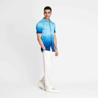 Angled front view of the blue ombre camp shirt with white trousers