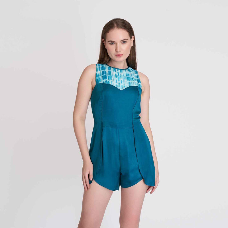Front view of the teal romper with a light blue printed yoke panel