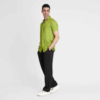 Side view of the solid neon green camp shirt with black trousers