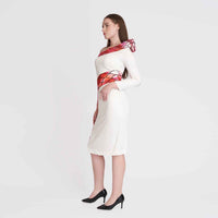 Side view of the white one-shoulder dress with the red snake-print detail