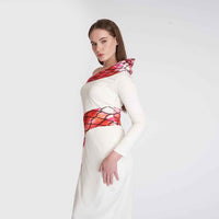 Close-up side view of the white dress showing the ruffle shoulder and snake-print band