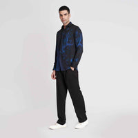 Side view of the black and blue tie-dye print shirt with black trousers