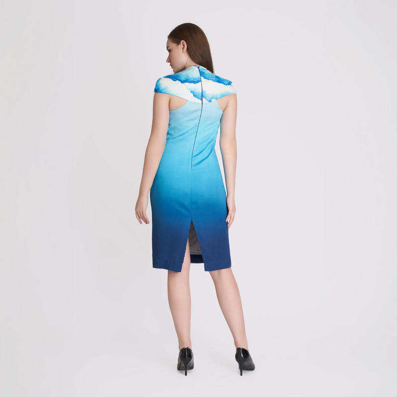 Back view of the ombre blue midi dress showing the cloud print yoke and back slit