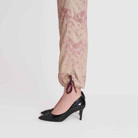 Close-up of the beige speckled print jogger cuff with tie detail