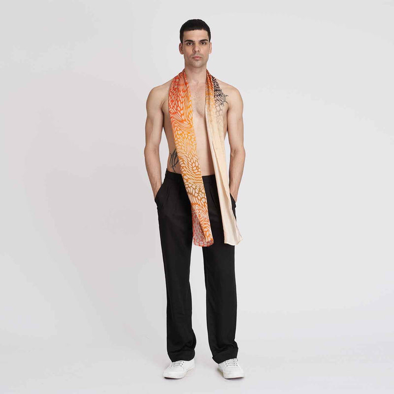 Front view of a man wearing the orange ombre scarf, full length with black trousers