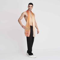 Side view of a man wearing the orange ombre butterfly print scarf with black trousers