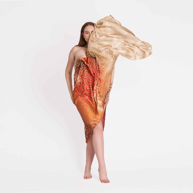 Model wearing the orange and gold ombre butterfly print scarf as a wrap dress