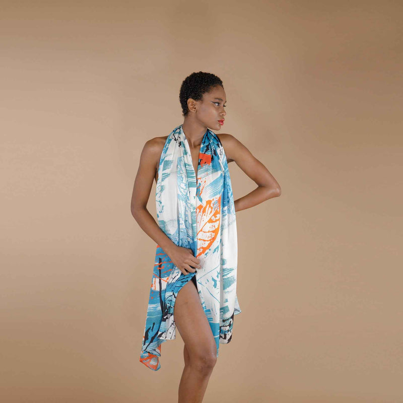 Side view of the blue and orange leaf print scarf styled as a wrap dress