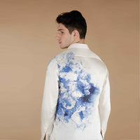 Back view of the cream shirt with a blue watercolor ink-wash print