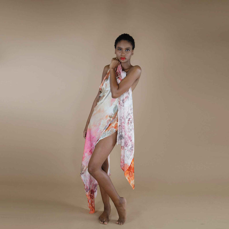 Close-up front view of the pink and orange floral print scarf draped as a wrap dress