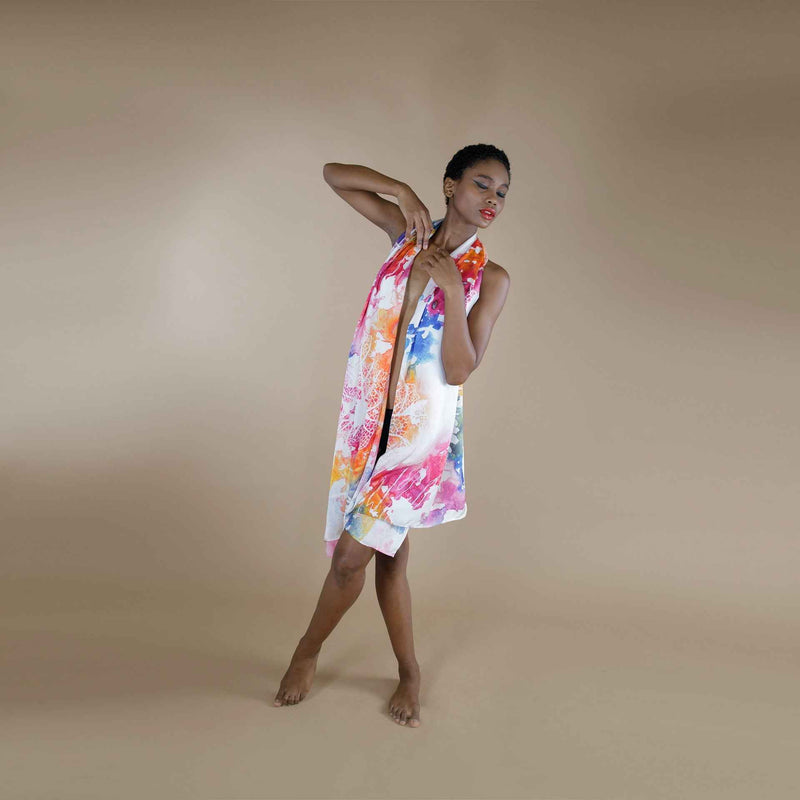 Model wearing the multicolor watercolor splash print scarf styled as a wrap dress