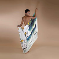 Model draped in the white scarf with a yellow floral and bird watercolor print