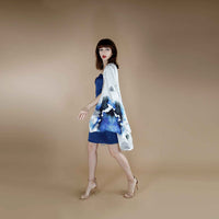 Side view of the blue and white floral kimono topper worn open over the blue slip dress