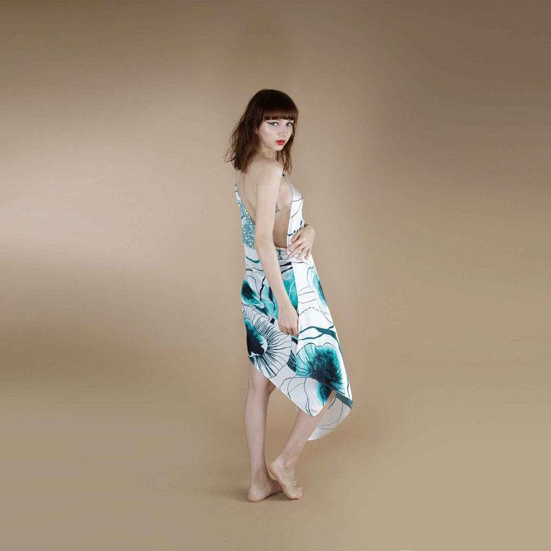 Front view of the teal green floral print scarf styled as a one-shoulder wrap dress