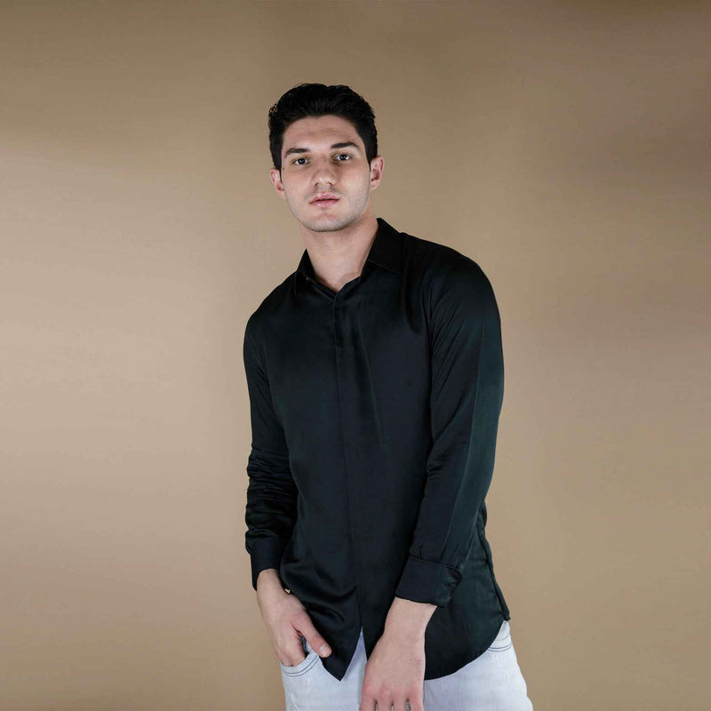 Front view of the solid dark green silk shirt with white trousers