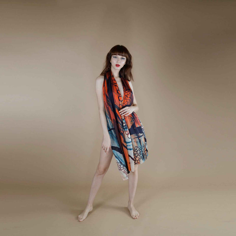 Front view of the orange and blue print scarf dress with the fabric spread out