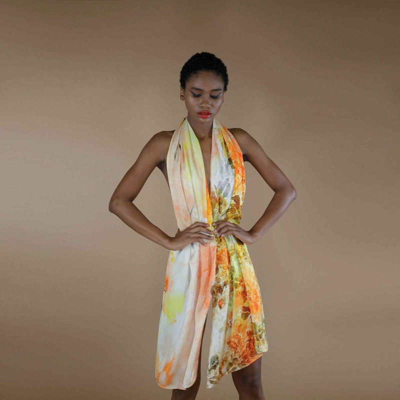 Front view of the yellow and orange floral watercolor print scarf worn as a halter dress