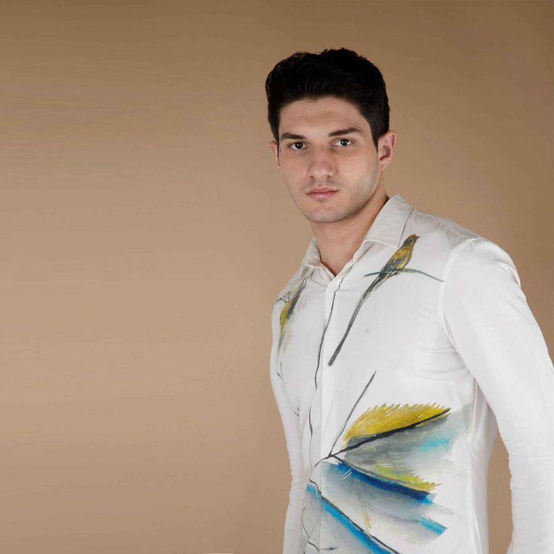 Close-up front view of the white shirt showing the bird and watercolor print detail