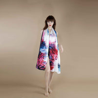 Front view of the pink and navy watercolor branch print scarf worn as a halter wrap dress