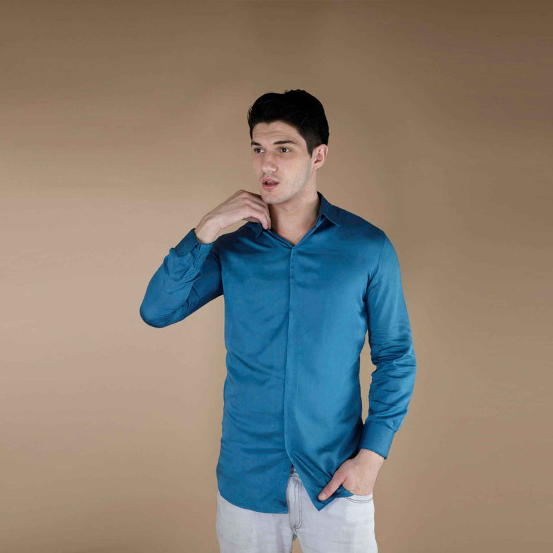 Front view of the solid teal blue silk shirt, worn open-collar with sleeves down