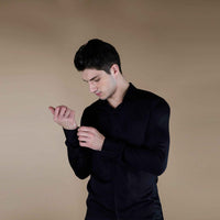 Front view of the solid black silk shirt with cuff detail
