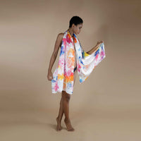 Model holding out the multicolor watercolor splash print scarf to show its full spread