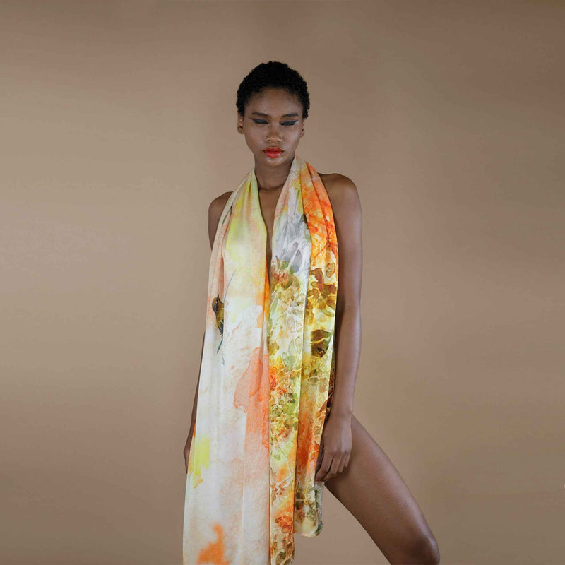 Close-up front view of the yellow and orange floral print scarf draped as a halter dress