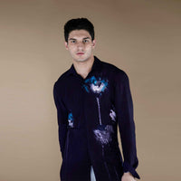Front view of the deep purple shirt with an abstract multicolor print