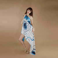 Front view of the blue floral line-art print scarf worn as an asymmetric wrap dress