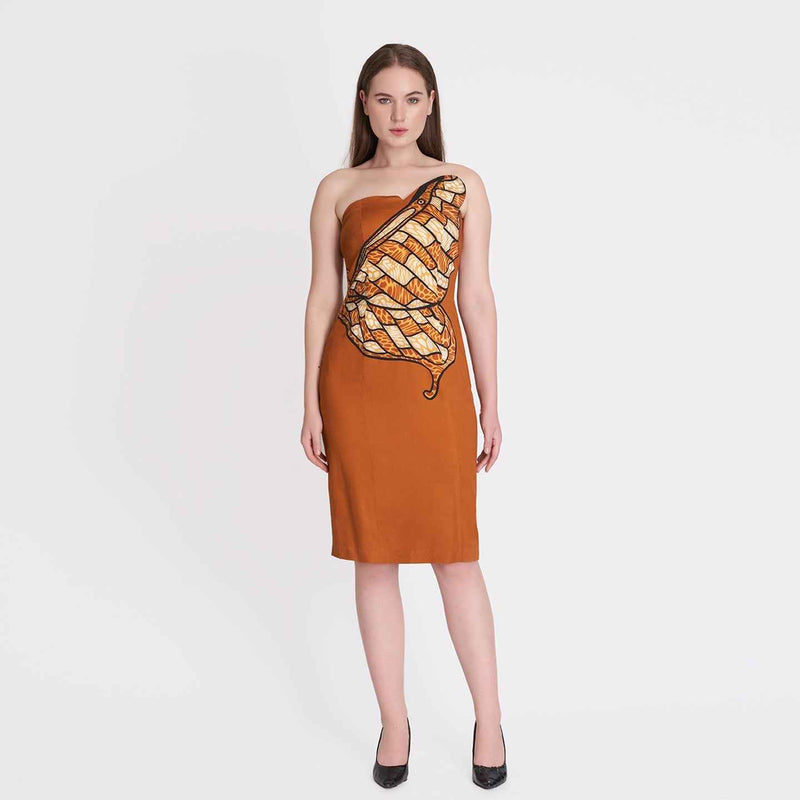 Front view of the rust orange strapless dress with a butterfly wing graphic print