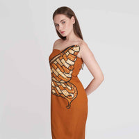 Close-up side view of the rust orange strapless dress showing the butterfly wing graphic print