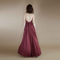 Back view of the maroon halter top showing the open back and pleated cape