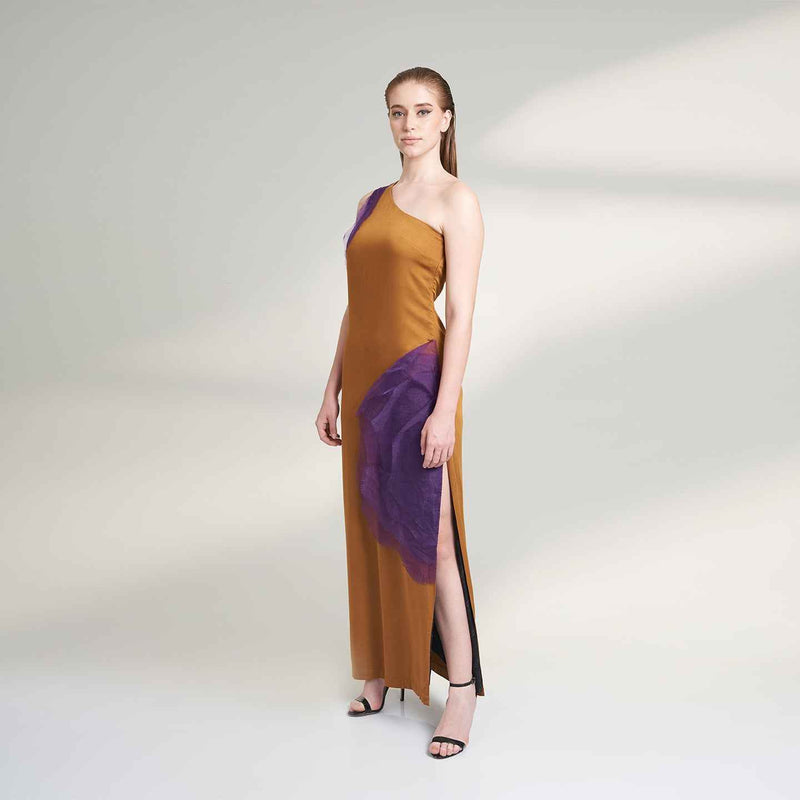 Angled front view of the long mustard dress with a draped purple organza panel