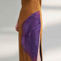 Close-up of the mustard dress side slit with the purple organza panel detail