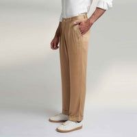 Angled side view of the beige pleated trousers
