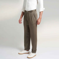 Side view of the olive green pleated trousers