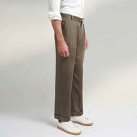 Angled side view of the olive green pleated trousers