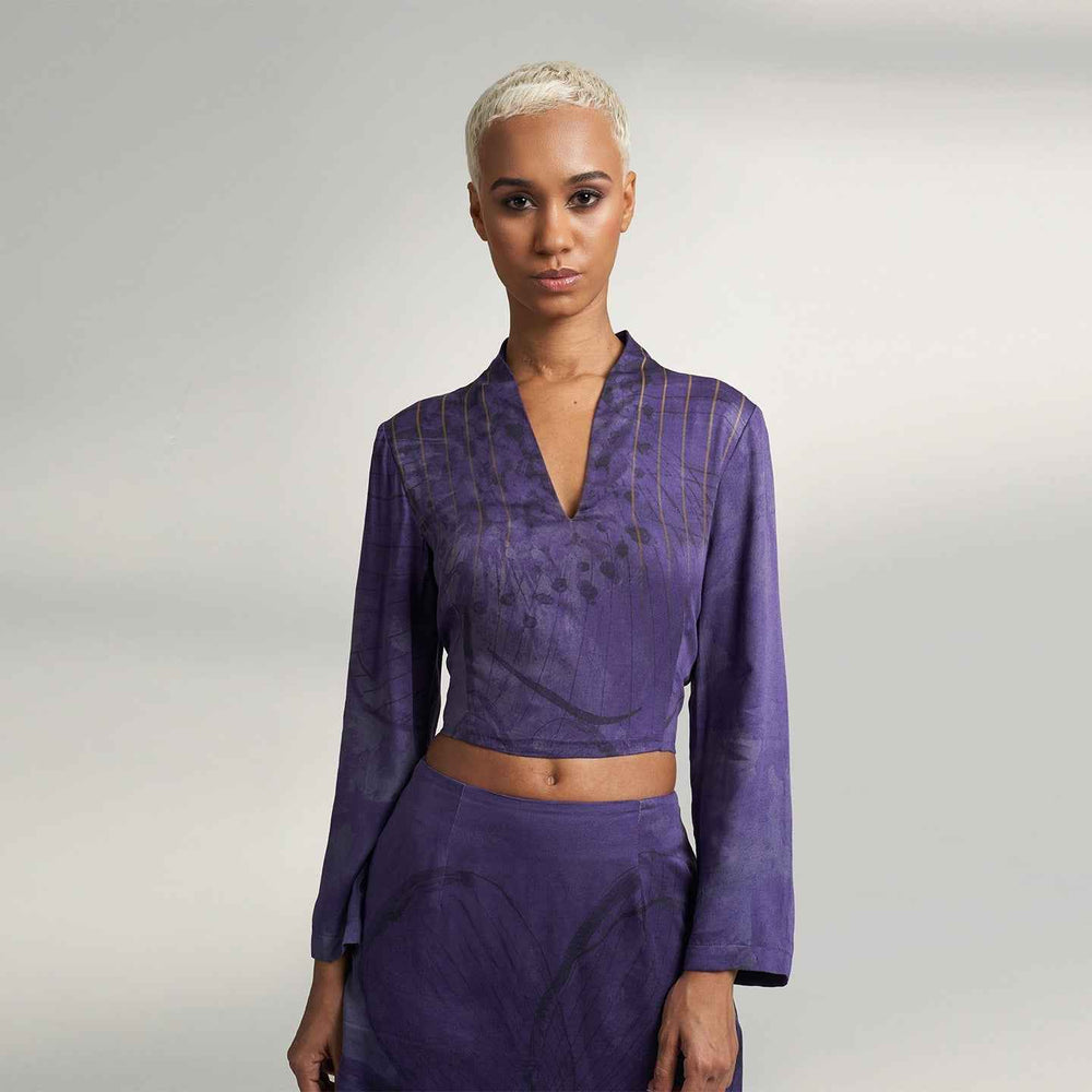 Close-up front view of the purple tonal floral print crop top with a V-neckline