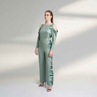 Angled front view of the sage green jumpsuit showing the cowl neck and cold-shoulder sleeves