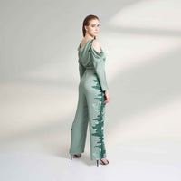 Back view of the sage green cold-shoulder jumpsuit showing the cowl drape