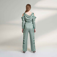 Back view of the sage green jumpsuit with tonal floral print panel detail