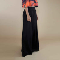 Angled side view of the black wide-leg palazzo trousers