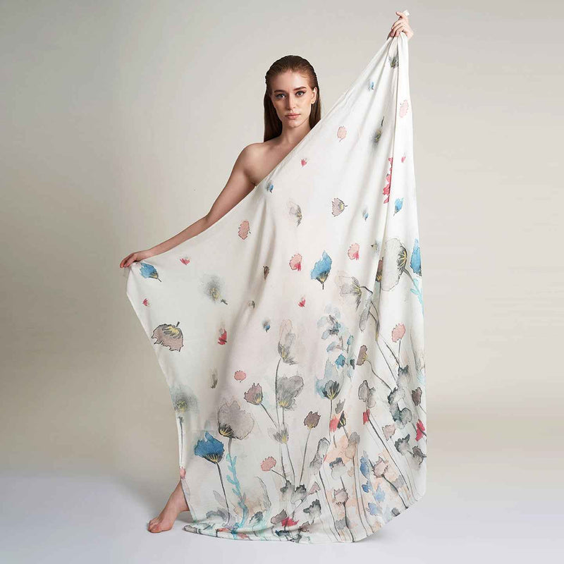 Front view of the model draped in the white floral print scarf