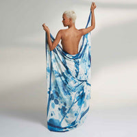Close-up of the model holding out the blue and white splatter print scarf