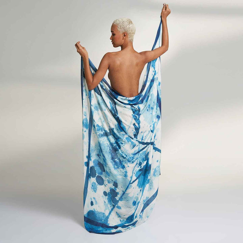 Close-up of the model holding out the blue and white splatter print scarf