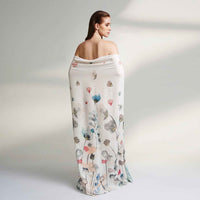 Back view of the model wrapped in the white floral print scarf